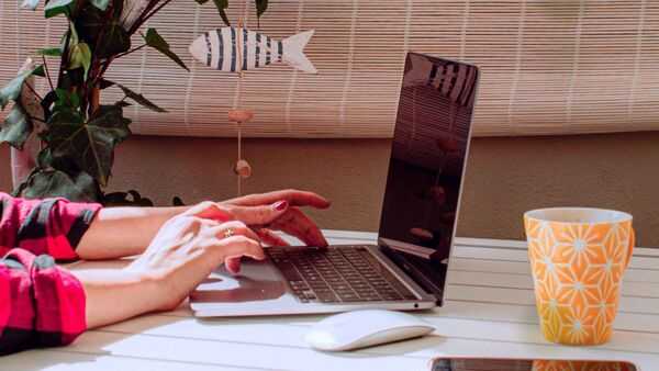 A calm workspace with a laptop and notebook in soft light